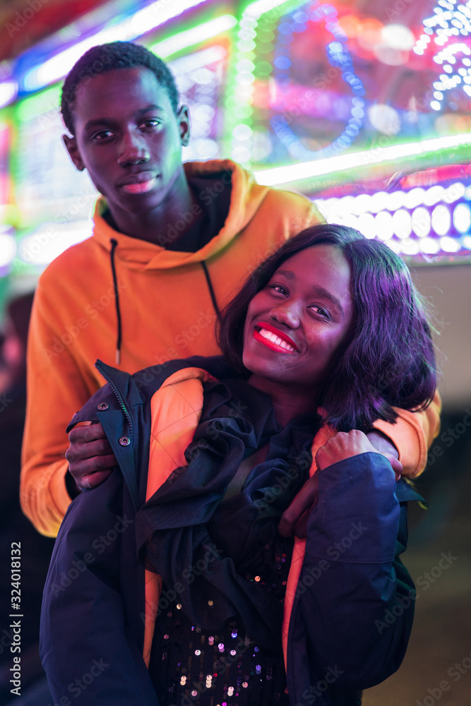 Black couple resting on fairground Black couple resting on fairground