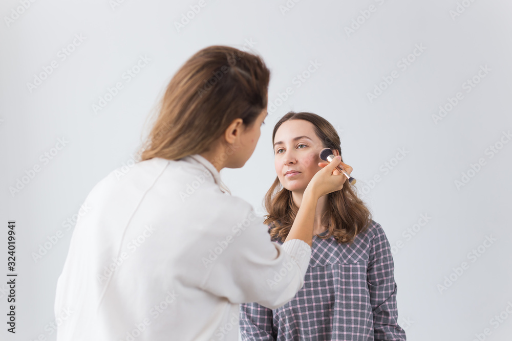 Beauty and cosmetics concept - Make-up artist doing professional make up of young woman Beauty and cosmetics concept - Make-up artist doing professional make up of young woman