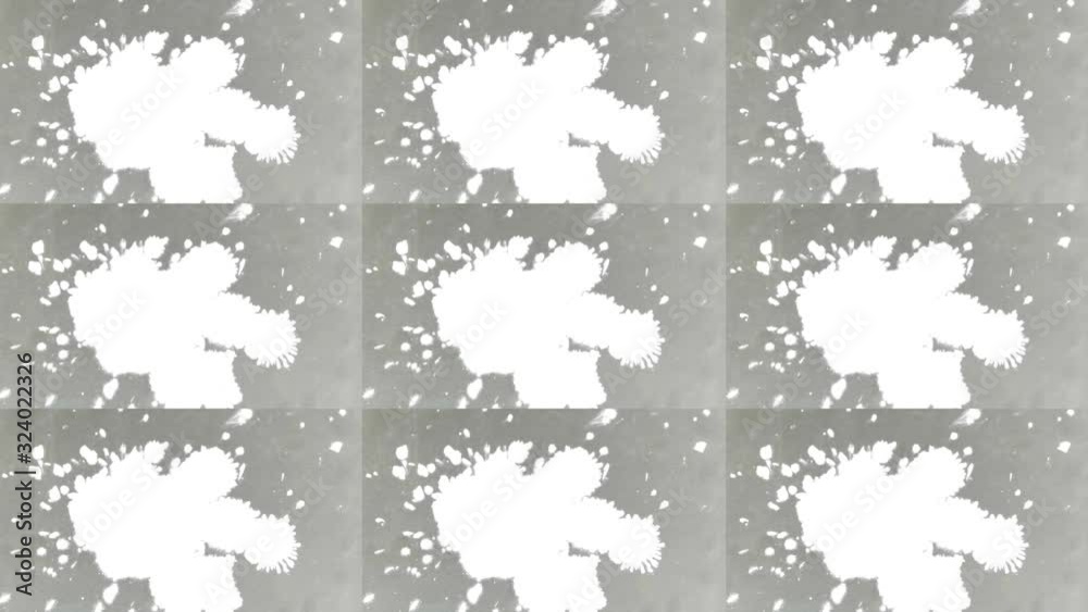 , Isolated White ink droplets fall on gray paper close up. , Isolated White ink droplets fall on gray paper close up.