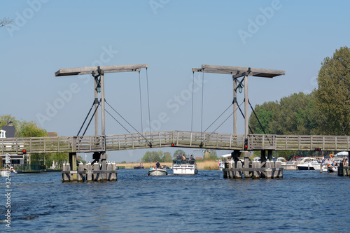 Landscape with waterways and canals of North Holland with boats, canal-side lifestyle in the Netherlands photo