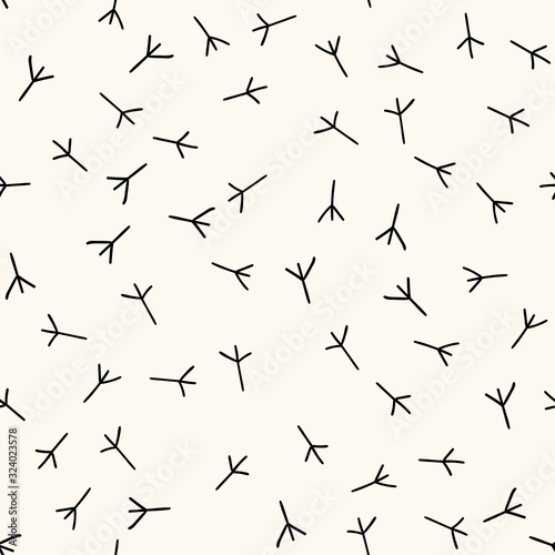 Seamless vector pattern with trace of bird paws, chicken footprints in handdrawn doodle style. Bird steps background.