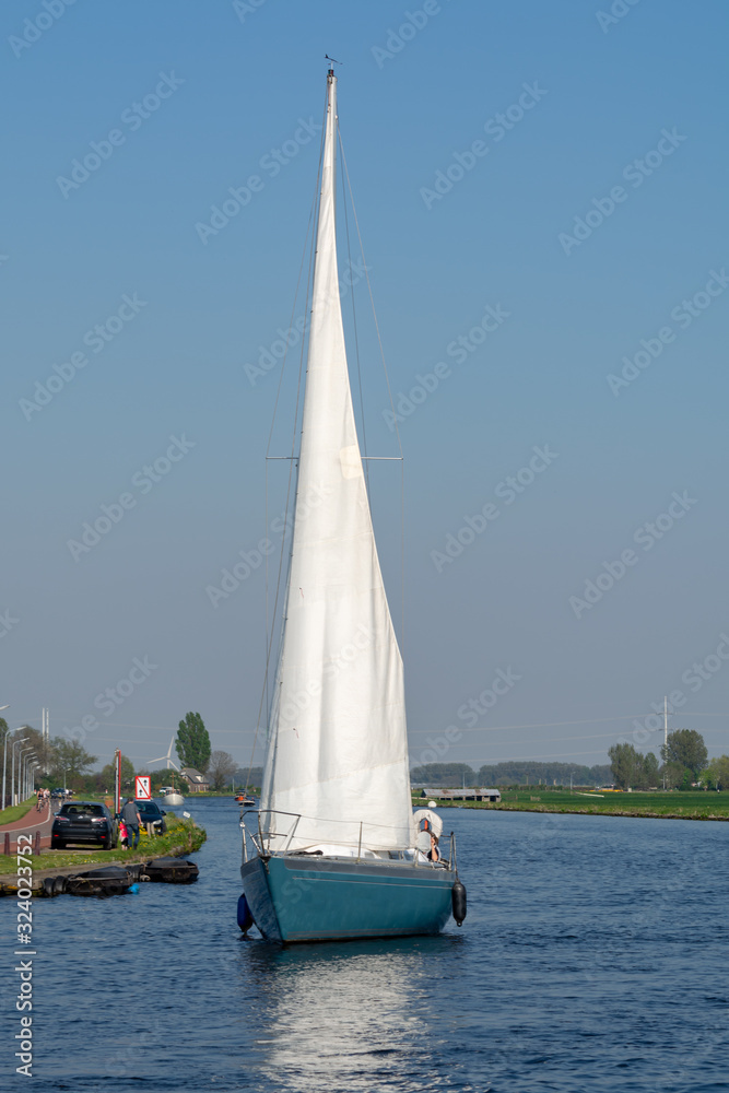 Landscape with waterways and canals of North Holland with boats, canal-side lifestyle in the Netherlands Landscape with waterways and canals of North Holland with boats, canal-side lifestyle in the Netherlands