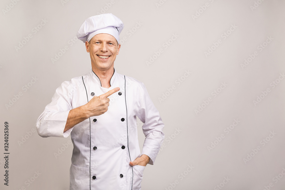 Senior cook man isolated showing a copy space with pointing finger. Senior cook man isolated showing a copy space with pointing finger.