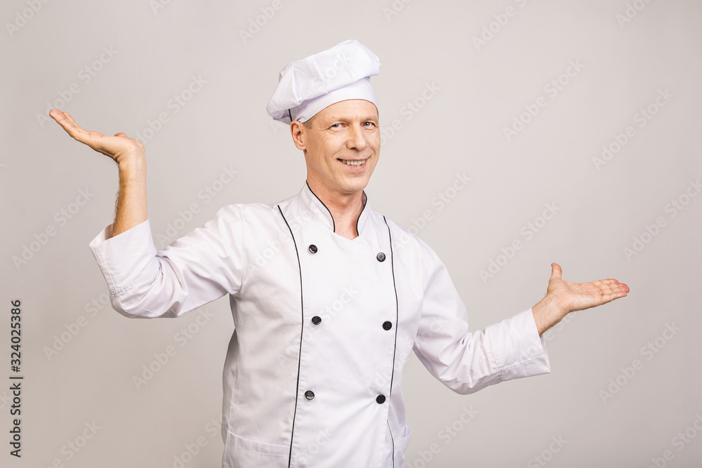 Senior cook man isolated showing a copy space on a palm. Senior cook man isolated showing a copy space on a palm.