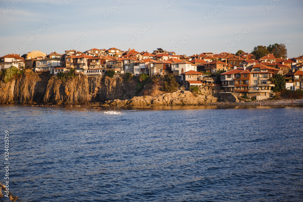 The sea coast of Bulgaria is a sandy beach with Golden sand and rocky high banks with tiled roofs of houses. The Balkan coast, the sea in Sozopol