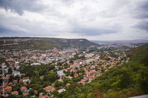 Red tile roofs in a mountain valley. View of the Bulgarian village from above, from the Ovech fortress