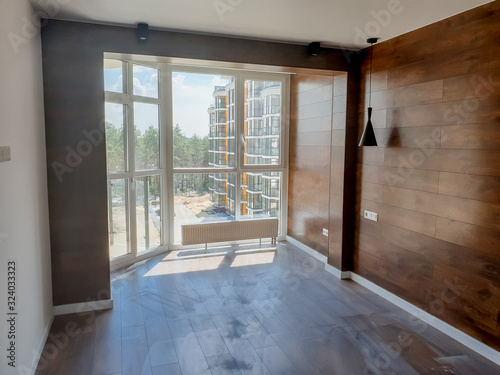 Modern empty interior with wooden panels on walls and wide windows
