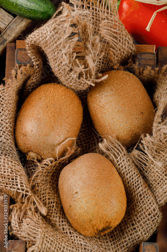 Fresh kiwies on a piece of burlap. photo