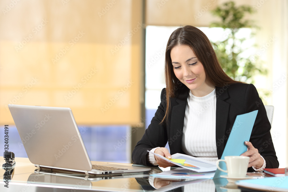 Serious executive checking documents at office Serious executive checking documents at office