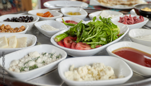 Тraditional turkish breakfast-cheese, olives, vegetables, yogurt, candied fruit, jam