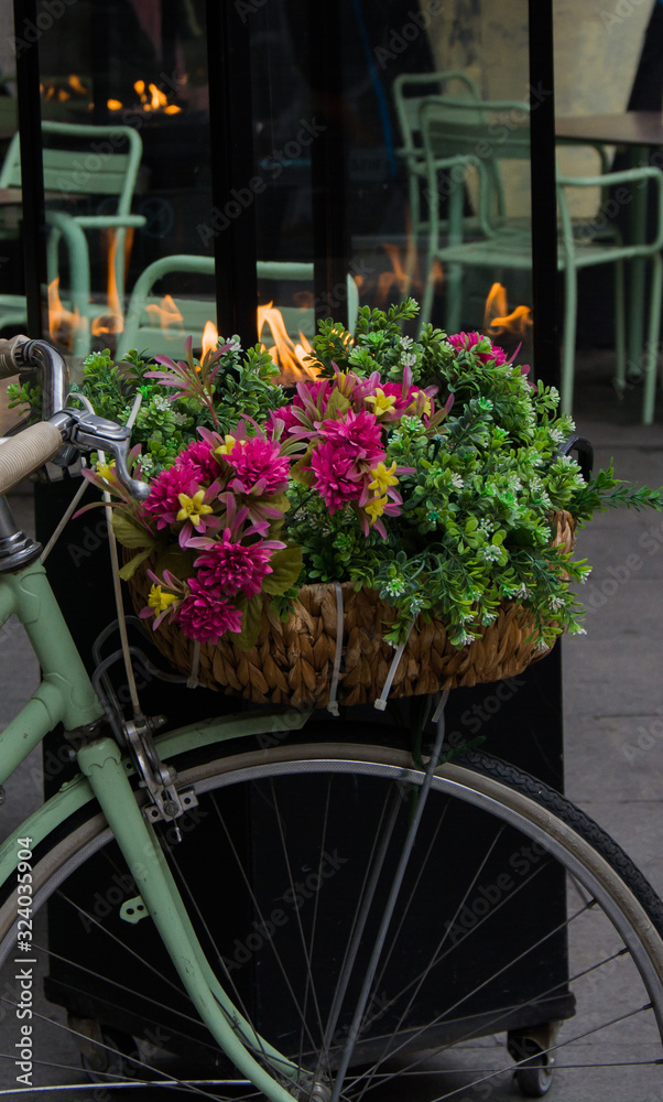 Romantic cityscape, bicycle, flowers and fire