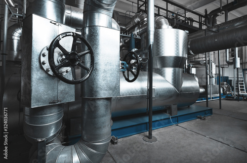 Modern industrial boiler room with Rankine organic cycle turbine (ORC-turbine) installed. Blue toning photo