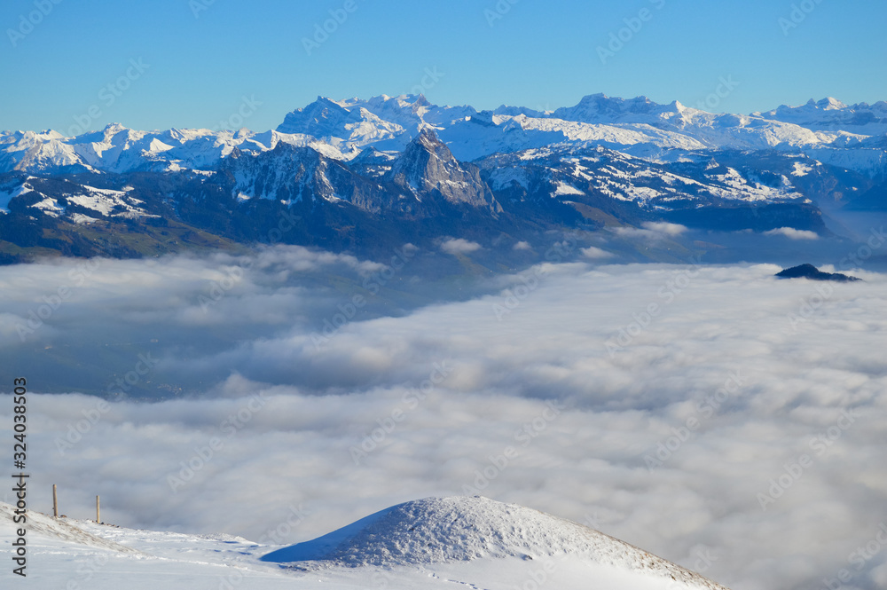 Fototapeta premium Snowy mountains with clouds