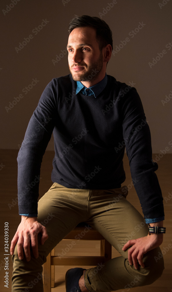 Portrait of a sitting handsome man happy expression. Stylish attitude. Businessman with watch.