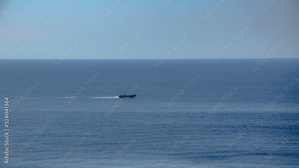 A large boat flies quickly across the sea. Sunny day. Travel and adventure. A large boat flies quickly across the sea. Sunny day. Travel and adventure.