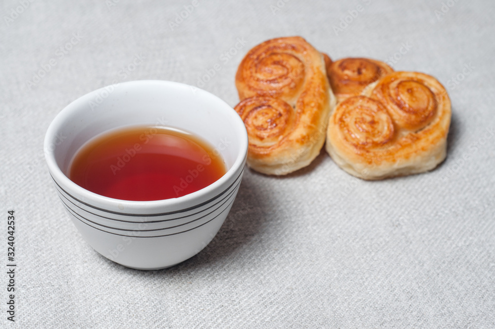 Tea mug and fresh pastries. Light morning breakfast. Fresh homemade cakes Tea mug and fresh pastries. Light morning breakfast. Fresh homemade cakes