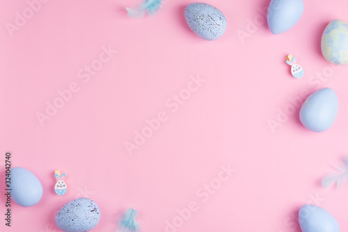 Beautiful Easter pastel blue eggs on pink background with copy space