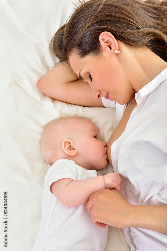 Young mother breastfeeds her baby. Breast-feeding. Young mother breastfeeds her baby. Breast-feeding.