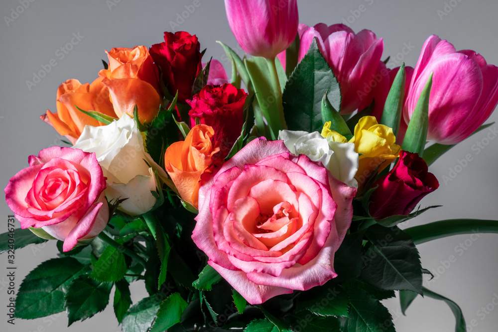 Bouquet of colorful roses and tulips with neutral background