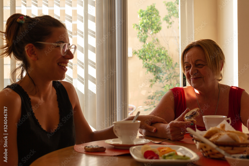 two woman drinking coffee and eating healthy food