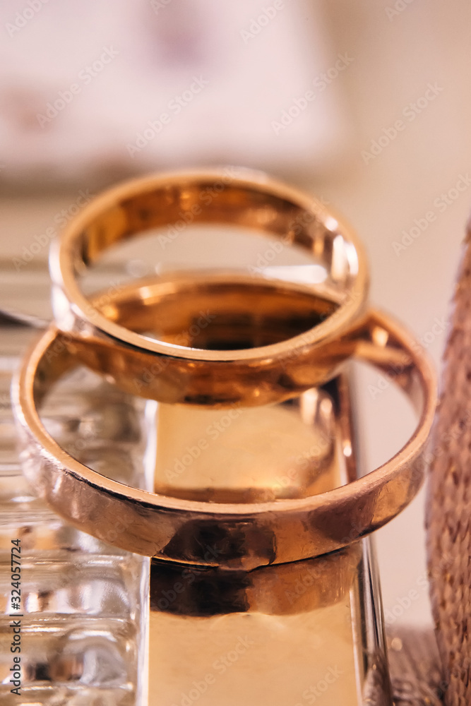 golden wedding rings on bright background