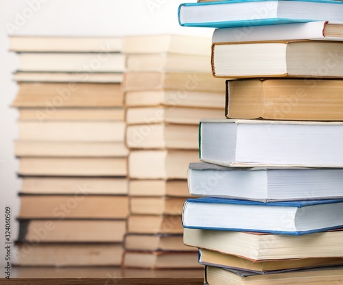 Different books collection in pile on the desk