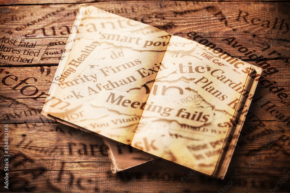 Fototapeta premium Vintage open book on old wooden table