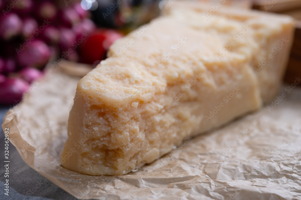 One piece of authentic Parmigiano-Reggiano or Parmesan Italian hard, granular cheese One piece of authentic Parmigiano-Reggiano or Parmesan Italian hard, granular cheese