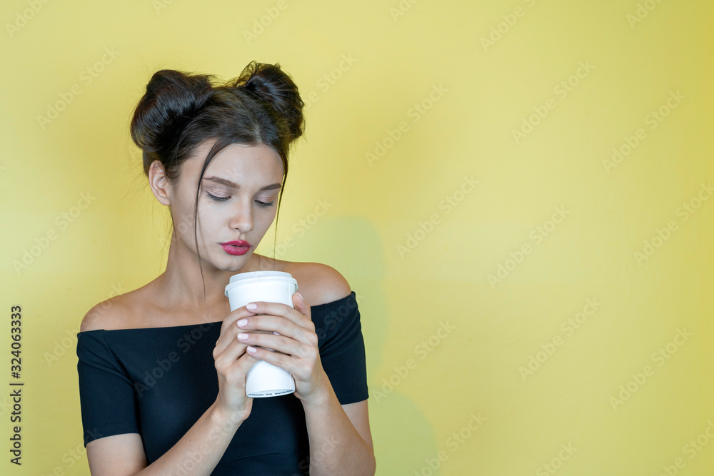 Young pretty woman with take away coffee cup. Young girl at yellow background, copy space... Young pretty woman with take away coffee cup. Young girl at yellow background, copy space...