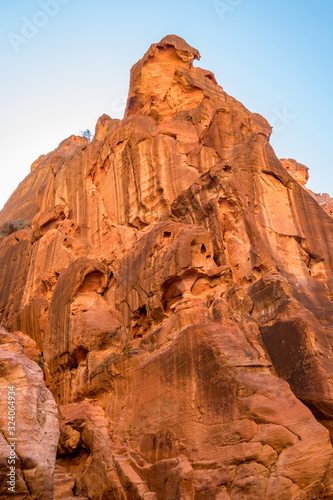 Breathtaking natural gorge called Al-Siq  carved in the red cliffs by the water flow  Petra ancient city complex and tourist attraction  Hashemite Kingdom of Jordan. Sunny winter day  cloudless sky