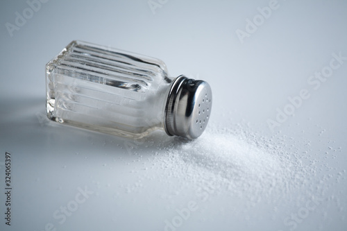 Vintage Salt Shaker with Salt on a White Background