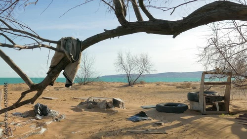 Abandoned deserted shore with garbage after hurricane	Disorder on the seashore at the tourist camp after hurricane in the off-season