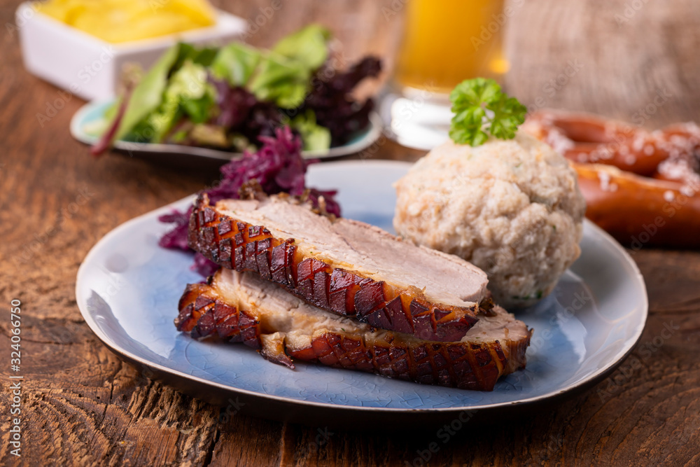 portion of fresh roasted pork on a blue plate portion of fresh roasted pork on a blue plate