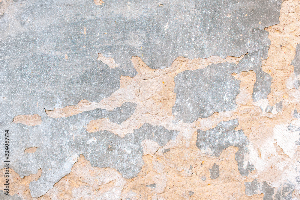 Fototapeta premium old plaster with cracks. environmental impact on buildings. cement-gypsum plaster. Coarse structure background. Grunge uneven surface of old street stone.