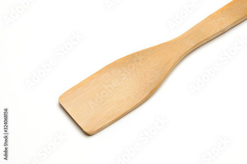 Wooden spatula from kitchen utensils on a white background