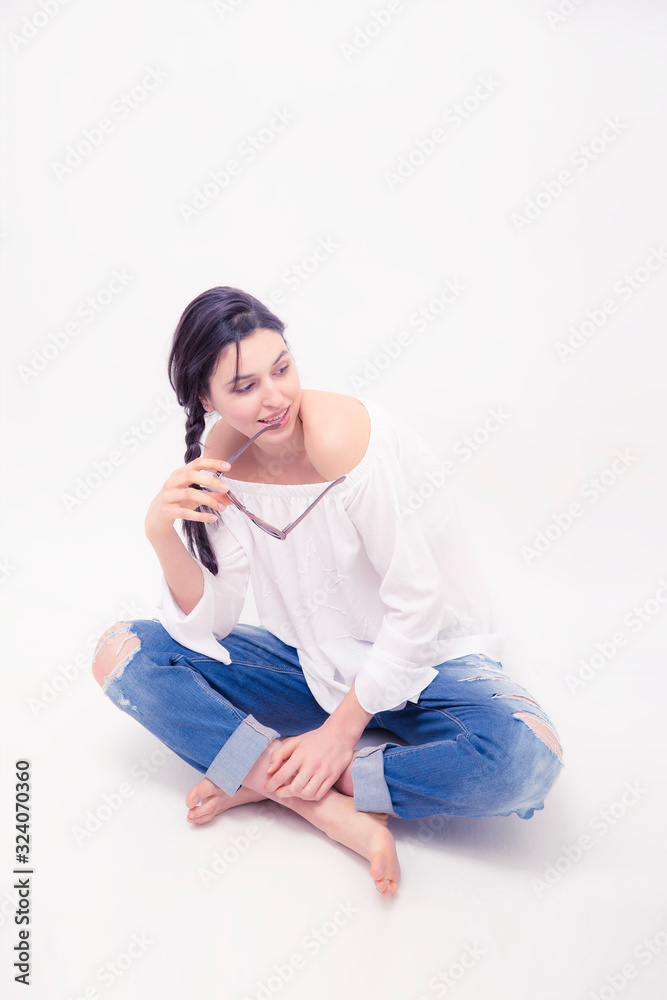  Brunette woman model with blue jeans sitting on white background