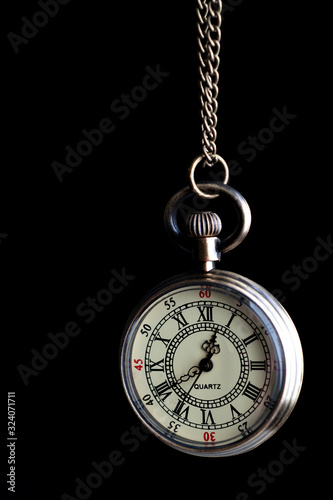  vintage pocket watch on a chain of bronze color close-up on a black background