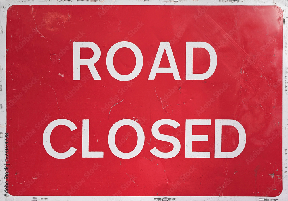 UK red and white ROAD CLOSED sign shot close up straight on. UK red and white ROAD CLOSED sign shot close up straight on.