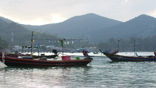 Wallpaper Mural Fishing boat swaying gently on the waves in a cozy bay Torontodigital.ca