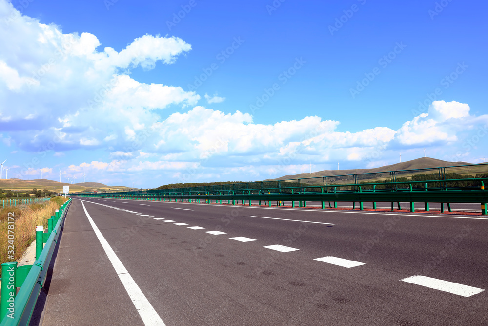 Fototapeta premium Empty highway, blue sky and white clouds landscape