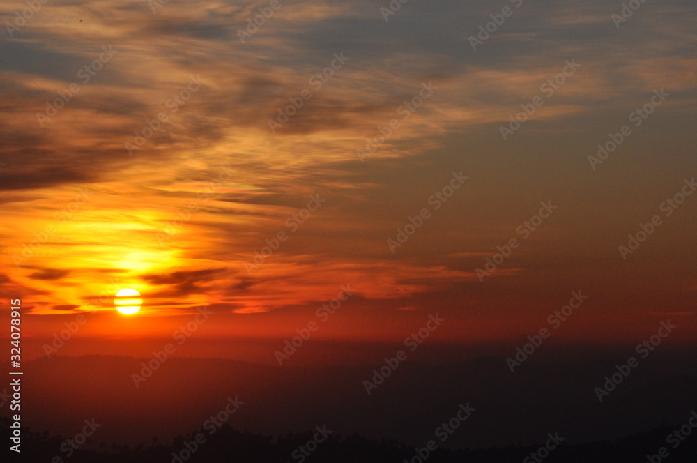 Orange sunset sky background with clouds