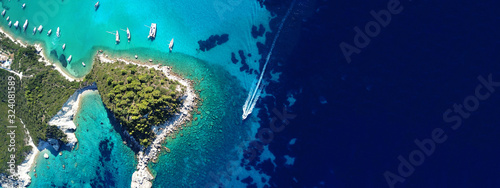 Fototapeta Naklejka Na Ścianę i Meble -  Aerial drone ultra wide photo of paradise turquoise bay and small village of Lakka visited by yachts and sail boats, Paxos island, Ionian, Greece