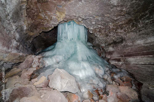 USA, California, Modoc County, Lava Beds National Monument. A lfrozen waterfall forming a large water ice flow formation photo