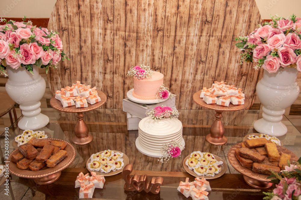 Wedding Setup. Cake table with sweet, decoration and flowers 