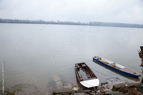 Boats and ships, some fishing ships and old and rusty abandoned boats standing on the riverbanks of the river Dabube on Zemunski Kej, in Zemun, a suburb of Belgrade, Serbia. photo