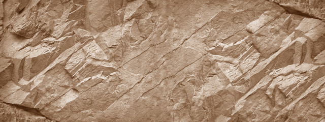 Stone wall. Light brown beige rock texture. Stone grunge backdrop. Rocky texture background with copy space for design. Web banner. Wide. Panoramic. Design.