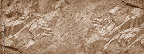 Stone wall. Light brown rock texture. Stone grunge backdrop. Rocky texture background with copy space for design. Web banner. Wide. Panoramic. photo