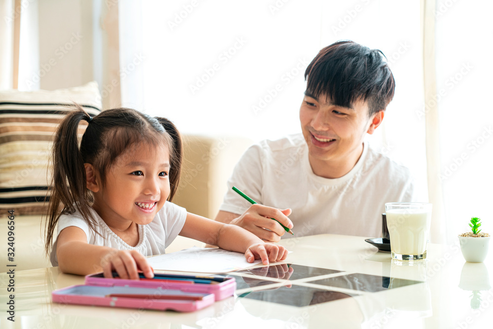 Beautiful Asian girl doing homework in her living room at sweet home in a relaxing day, Asian Family Concept Beautiful Asian girl doing homework in her living room at sweet home in a relaxing day, Asian Family Concept