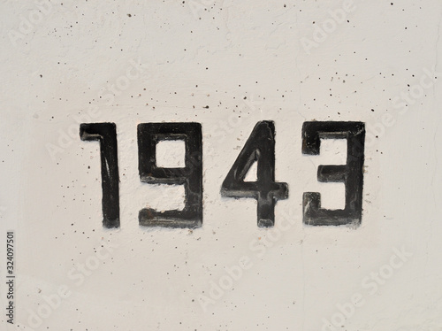 1943 Embossed on Concrete Wall