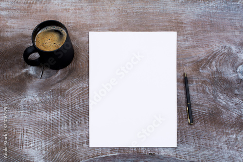 Blank paper sheet mockup with cofee mug photo